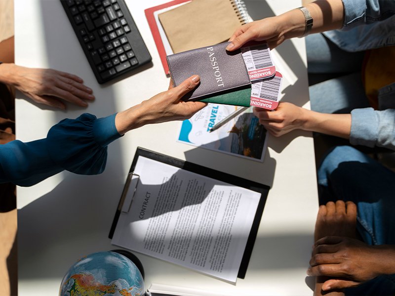 top-view-hands-holding-travel-documents